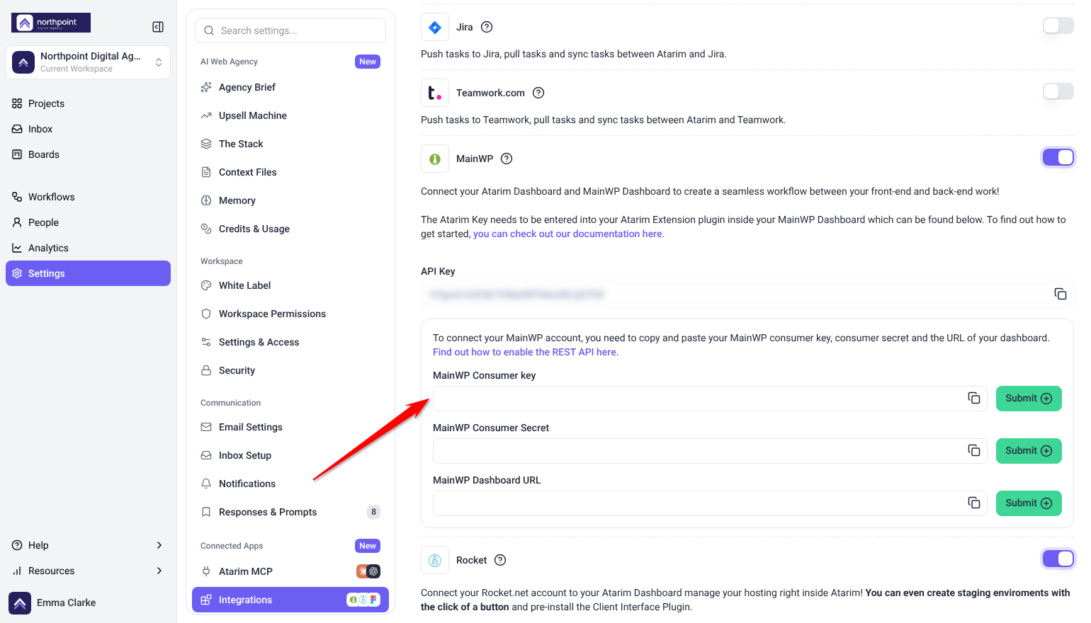 MainWP card switched on with the MainWP Consumer key, Consumer Secret and Dashboard URL fields and Submit buttons; the arrow points at Consumer key